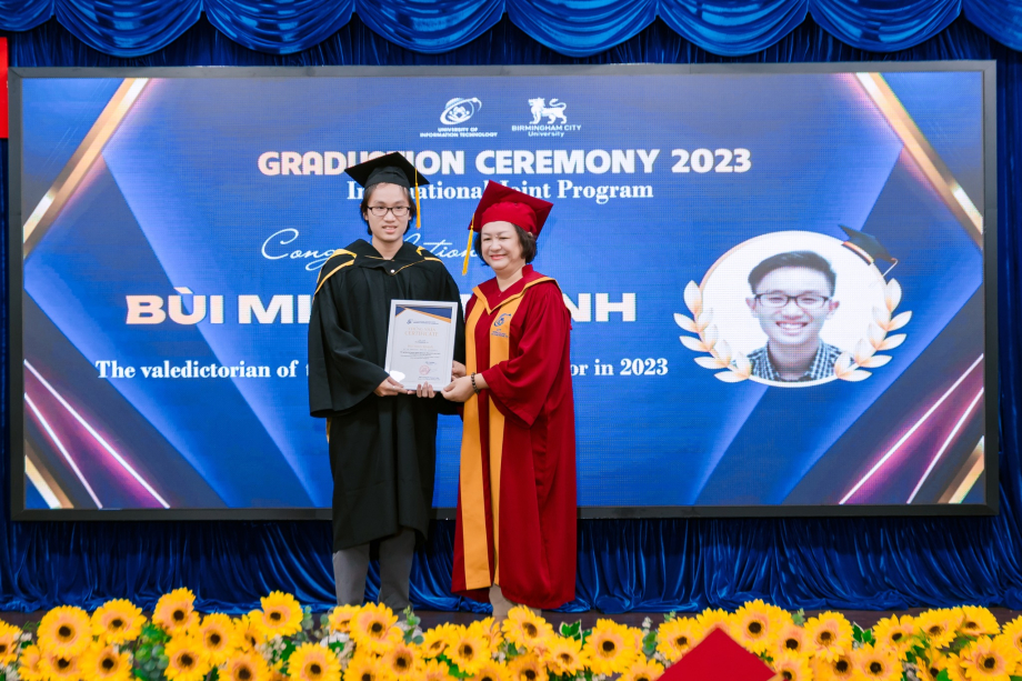 A person and person in graduation gowns

Description automatically generated