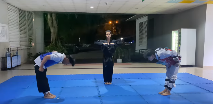 A person standing on a mat

Description automatically generated